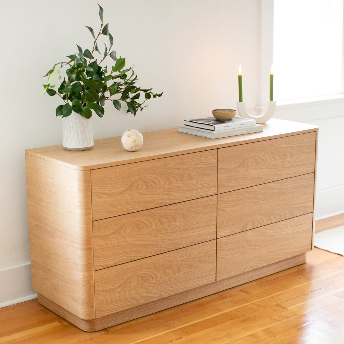 Wooden dresser with decorative items in a minimalistic room