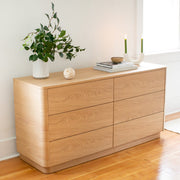 Wooden dresser with decorative items in a minimalistic room