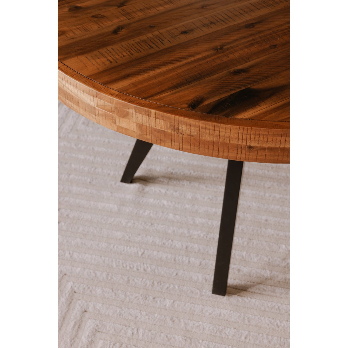 Wooden table with dark legs on a light gray carpet