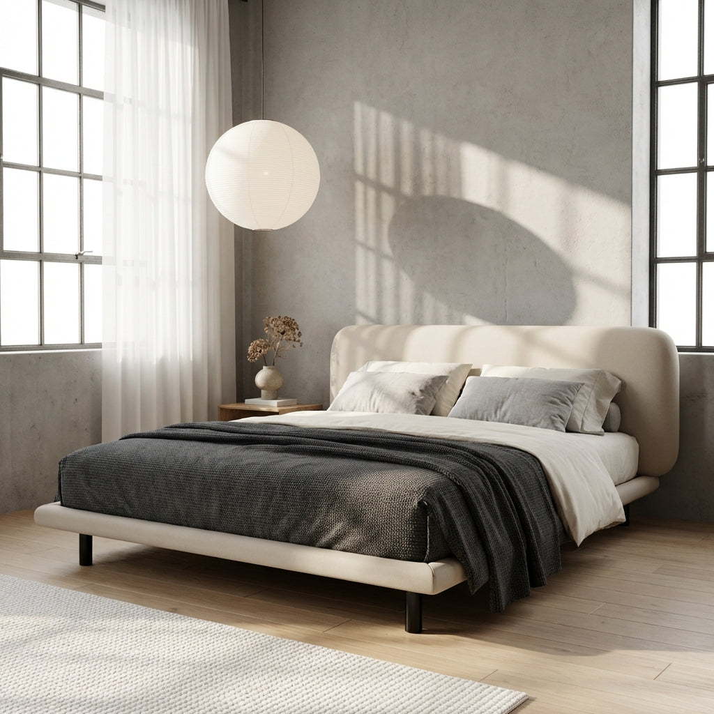 Modern bedroom with a bed, lamp, and decor elements.