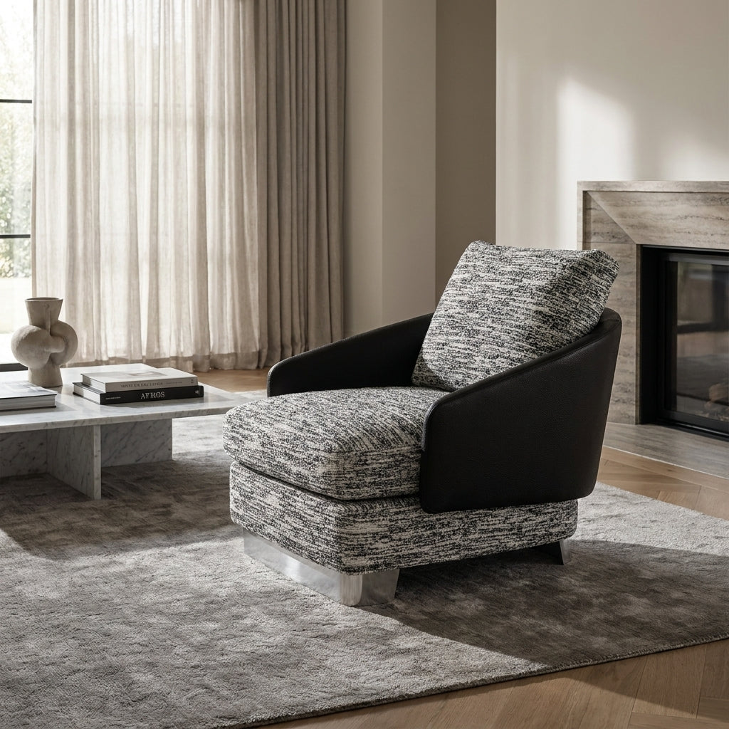 Modern armchair with patterned cushions in a living room setting.