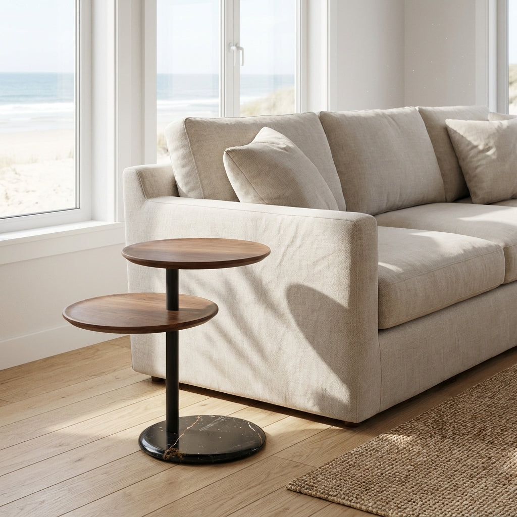 Beige sofa with a wooden side table in a bright room with large windows.