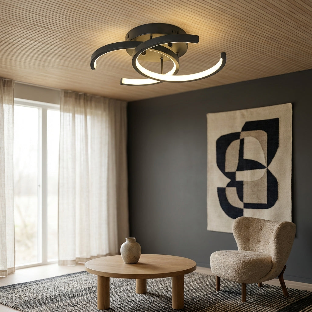 Modern living room with a ceiling light fixture, round table, and armchair.
