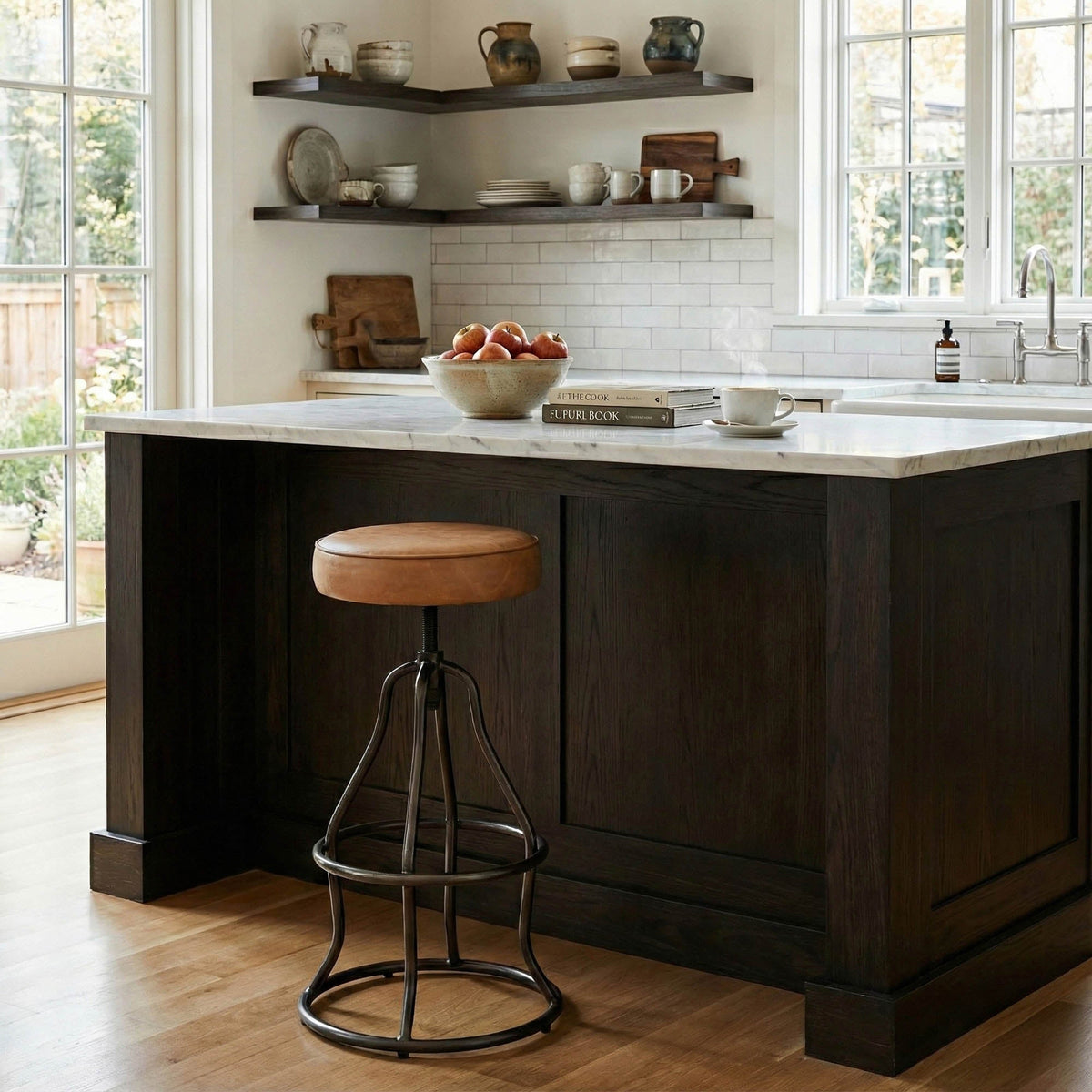 Kitchen island with bar stool in a well-lit kitchen