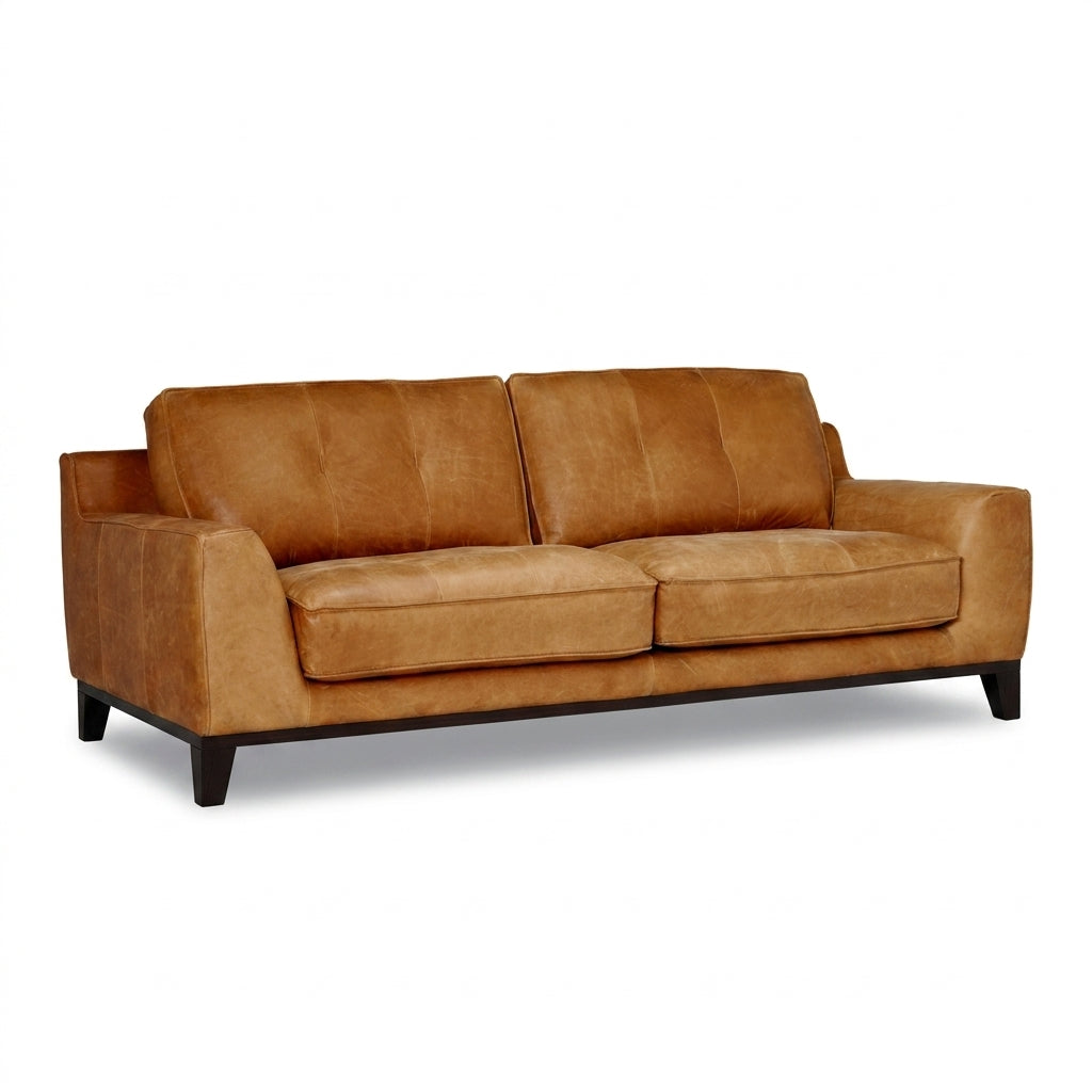 A modern two-seater sofa upholstered in warm tan leather with dark wooden legs, shown from a three-quarter angle on a white background.