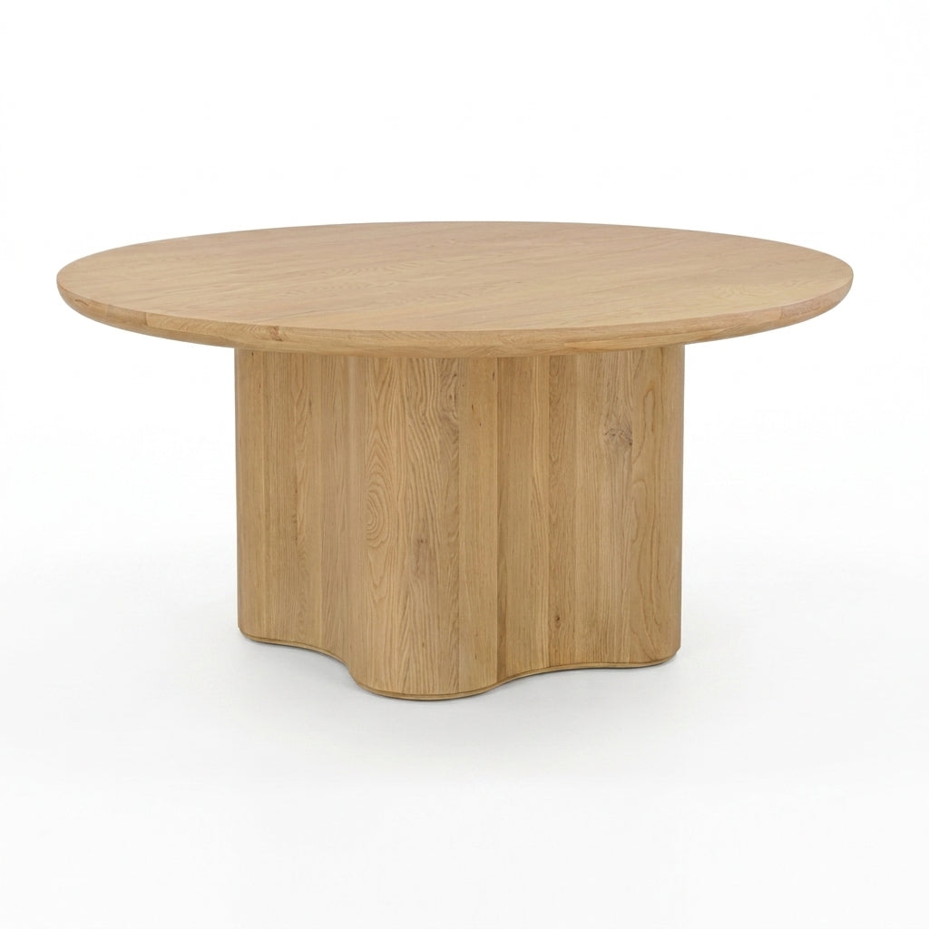 A round wooden dining table with a natural oak finish, featuring a fluted pedestal base and a smooth circular tabletop, shown on a clean white background.