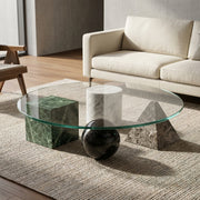 Glass coffee table with marble bases in a modern living room setting