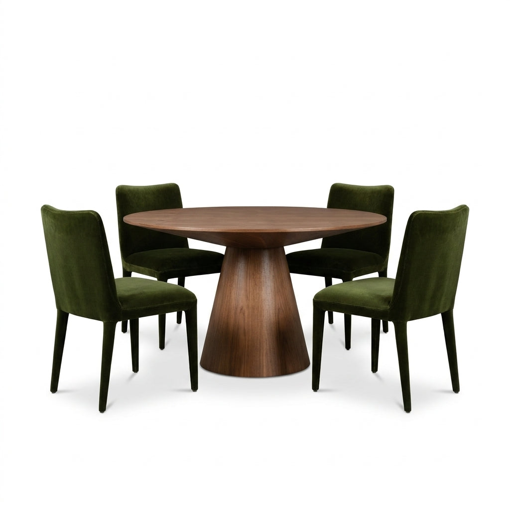 A round wooden dining table with a tapered pedestal base, surrounded by four dark green velvet upholstered chairs with slim black legs, shown on a white background.