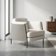Beige armchair in a modern room with a wooden sideboard.
