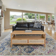 Corwin Coffee Table in natural oak with cane drawers in a bright living room