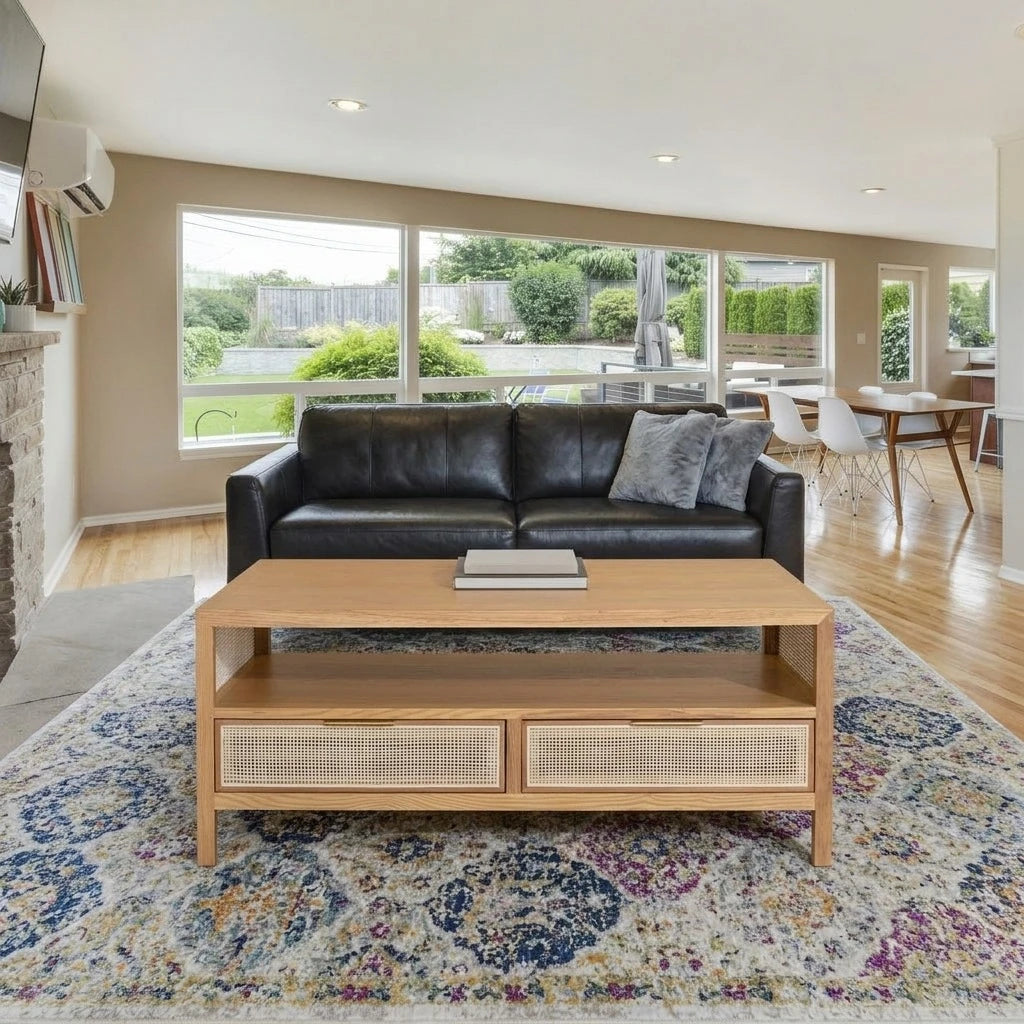Corwin Coffee Table in natural oak with cane drawers in a bright living room
