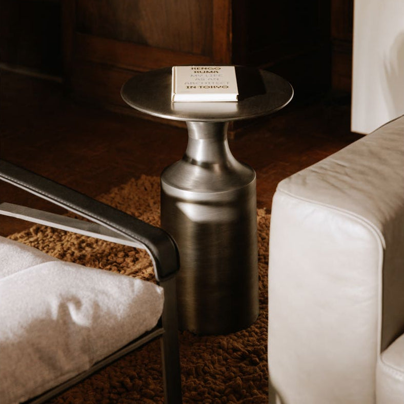 Rialto Accent Table in Polished Zinc — styled in a living room