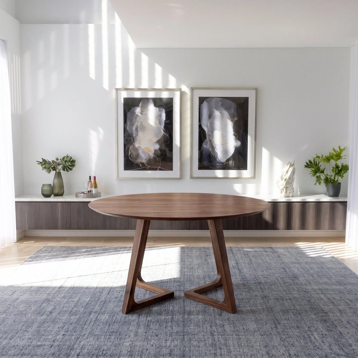 Gisborne Round Dining Table in Walnut on its own in a sunlit dining room