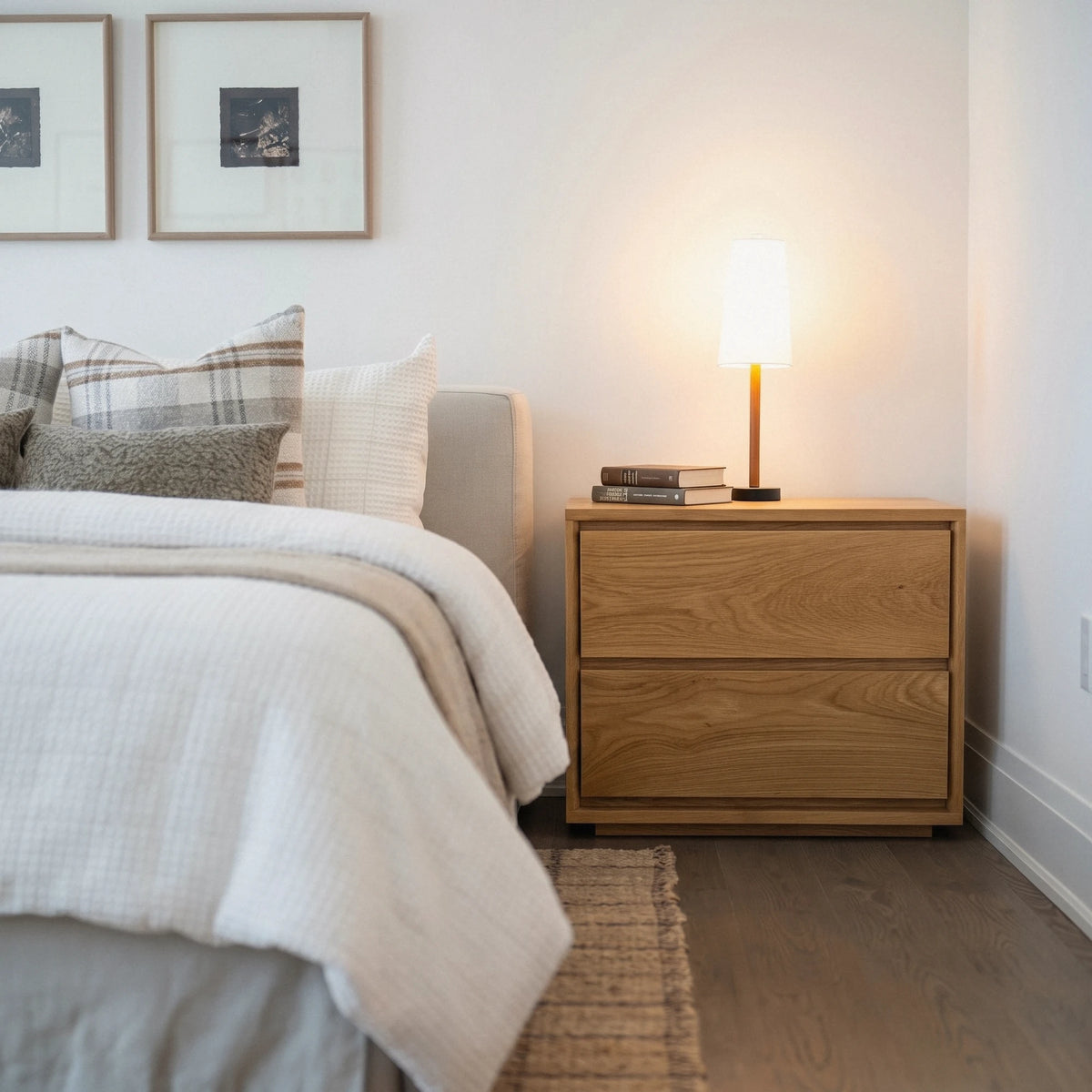 Timberton Nightstand in White Oak beside a bed